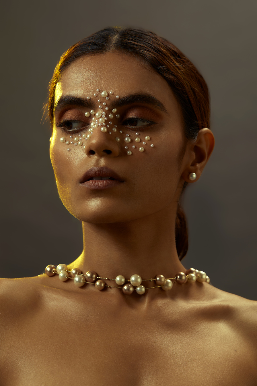 Elegant Woman with Pearl Makeup and Necklace